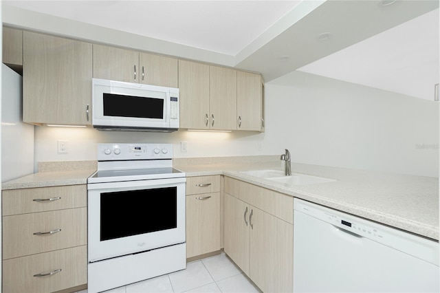 1551 Beach Rd Unit 212, Englewood, FL 34223 - kitchen with white appliances, light brown cabinets, a sink, light countertops, and light tile patterned floors