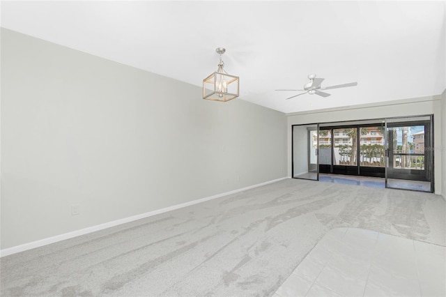 1551 Beach Rd Unit 212, Englewood, FL 34223 - unfurnished room featuring carpet floors, a chandelier, baseboards, and ceiling fan