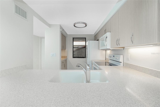 1551 Beach Rd Unit 212, Englewood, FL 34223 - kitchen with white appliances, a sink, and light countertops