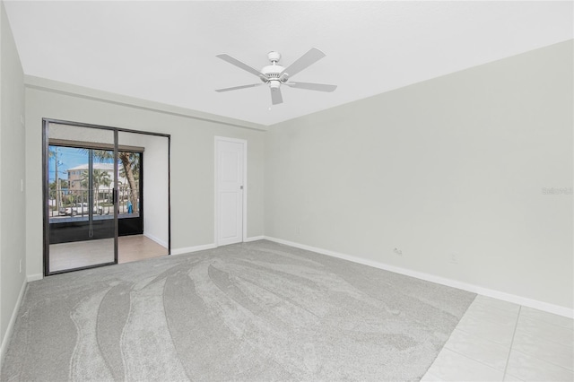 1551 Beach Rd Unit 212, Englewood, FL 34223 - unfurnished bedroom with access to exterior, baseboards, carpet, and ceiling fan