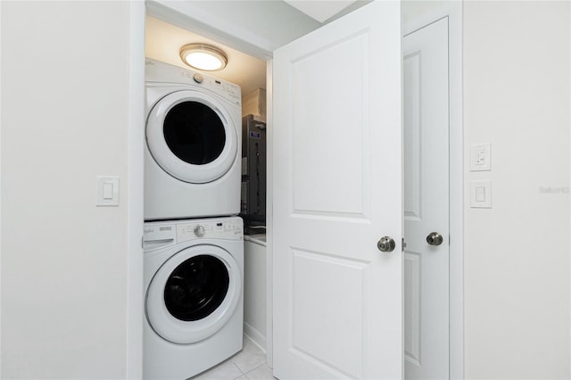1551 Beach Rd Unit 212, Englewood, FL 34223 - laundry room featuring estacked washer and dryer and light tile patterned floors
