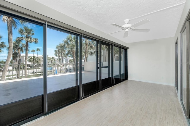 1551 Beach Rd Unit 212, Englewood, FL 34223 - empty room with a ceiling fan, baseboards, wood finished floors, and a textured ceiling