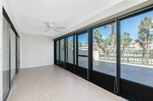 1551 Beach Rd Unit 212, Englewood, FL 34223 - spare room with baseboards, a ceiling fan, a textured ceiling, and wood finished floors