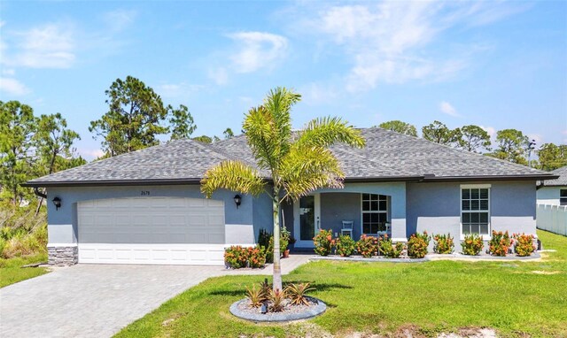 2678 Alva St, North Port, FL 34291 - ranch-style house with stucco siding, an attached garage, decorative driveway, and a front yard