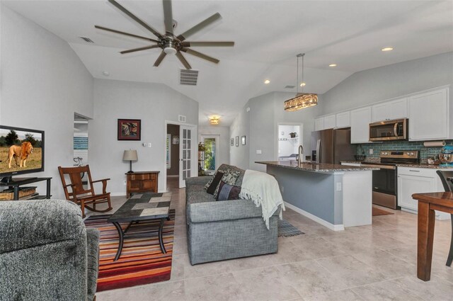2678 Alva St, North Port, FL 34291 - living area with ceiling fan, light tile patterned flooring, high vaulted ceiling, and recessed lighting