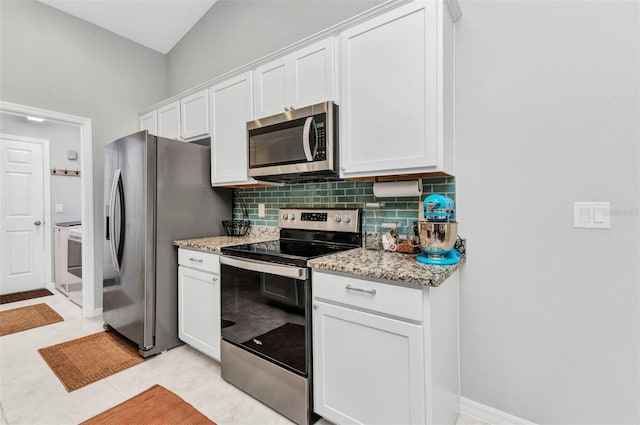 2678 Alva St, North Port, FL 34291 - kitchen with stainless steel appliances, backsplash, white cabinetry, light stone countertops, and light tile patterned floors