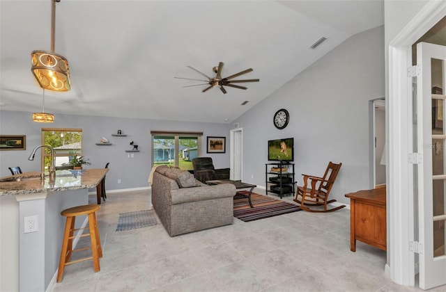 2678 Alva St, North Port, FL 34291 - living area with vaulted ceiling, ceiling fan, light tile patterned floors, and baseboards