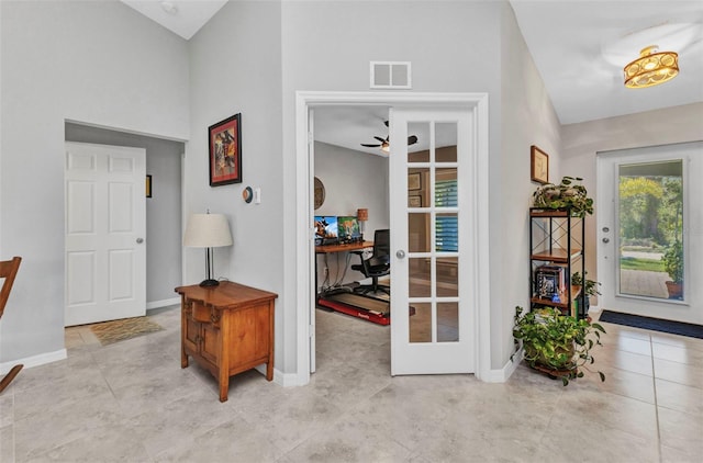 2678 Alva St, North Port, FL 34291 - foyer featuring baseboards, a ceiling fan, tile patterned floors, a high ceiling, and french doors