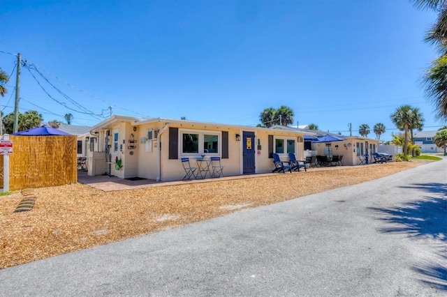 115 Friendship Ln, Englewood, FL 34223 - ranch-style house with stucco siding and a patio