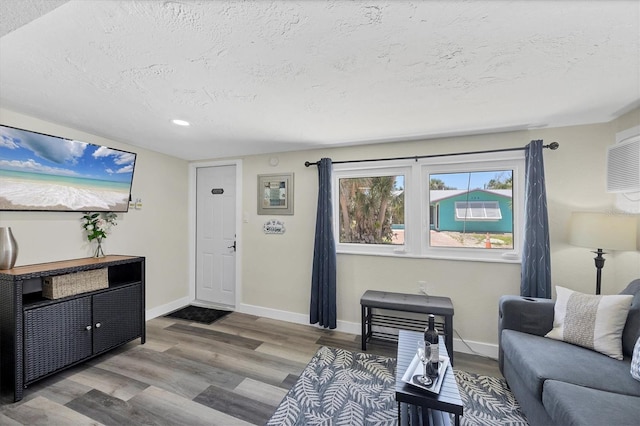 115 Friendship Ln, Englewood, FL 34223 - living area with a textured ceiling, wood finished floors, recessed lighting, and baseboards