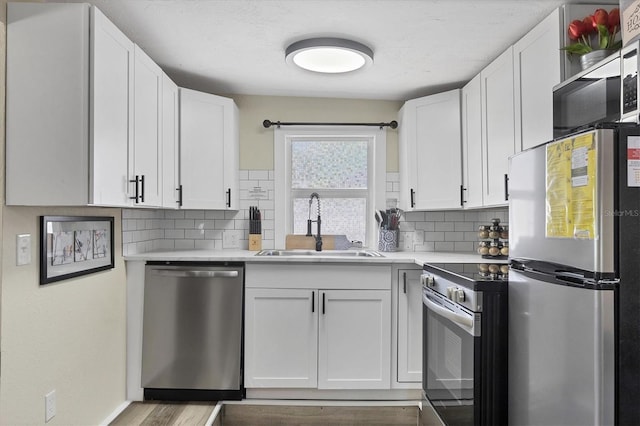 115 Friendship Ln, Englewood, FL 34223 - kitchen with appliances with stainless steel finishes, a sink, light countertops, and tasteful backsplash