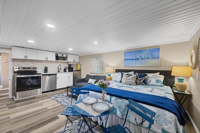 115 Friendship Ln, Englewood, FL 34223 - bedroom featuring a sink, freestanding refrigerator, light wood-type flooring, recessed lighting, and wooden ceiling