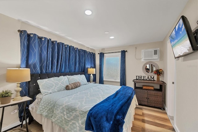 115 Friendship Ln, Englewood, FL 34223 - bedroom featuring a wall mounted air conditioner, wood finished floors, and recessed lighting
