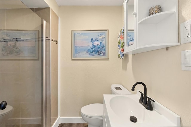 115 Friendship Ln, Englewood, FL 34223 - bathroom with toilet, a sink, a stall shower, and baseboards