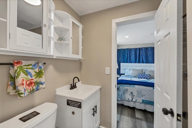 115 Friendship Ln, Englewood, FL 34223 - ensuite bathroom with wood finished floors, toilet, and vanity
