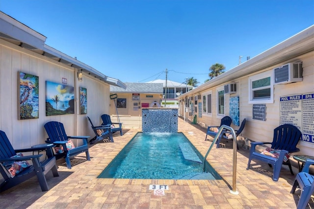 115 Friendship Ln, Englewood, FL 34223 - view of swimming pool featuring an AC wall unit and a patio area