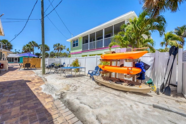 115 Friendship Ln, Englewood, FL 34223 - view of patio / terrace featuring outdoor dining area, a fenced backyard, and a sunroom