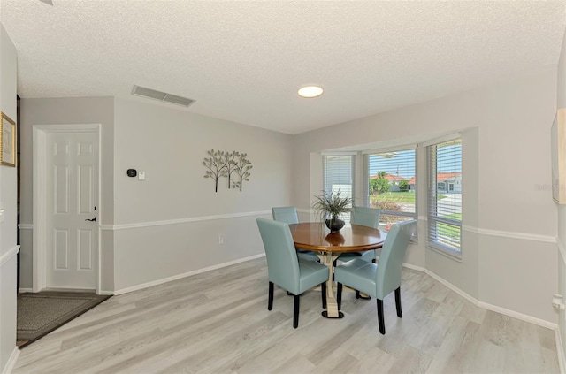 9869 Gulfstream Blvd, Englewood, FL 34224 - dining area with light wood-style floors, a textured ceiling, baseboards, and recessed lighting
