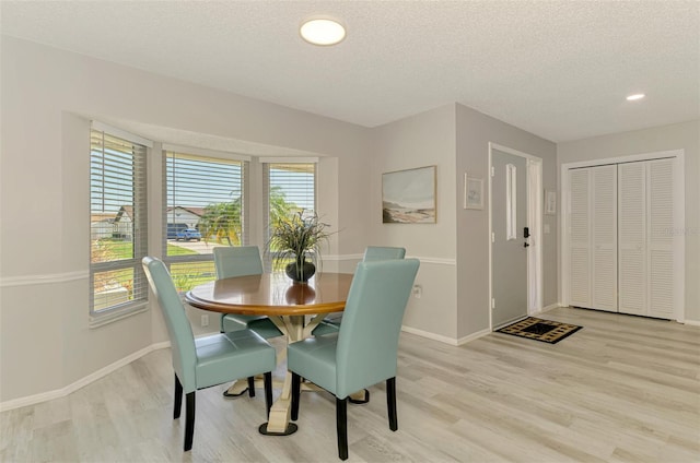 9869 Gulfstream Blvd, Englewood, FL 34224 - dining space featuring light wood-type flooring, a textured ceiling, baseboards, and recessed lighting
