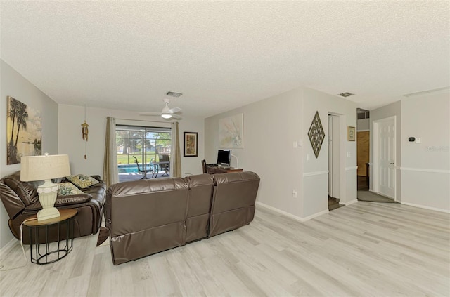 9869 Gulfstream Blvd, Englewood, FL 34224 - living room with a textured ceiling, wood finished floors, a ceiling fan, and baseboards