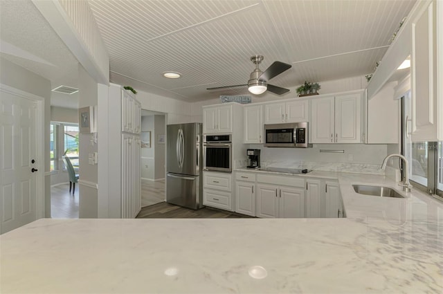 9869 Gulfstream Blvd, Englewood, FL 34224 - kitchen featuring appliances with stainless steel finishes, a sink, white cabinetry, a ceiling fan, and dark wood finished floors
