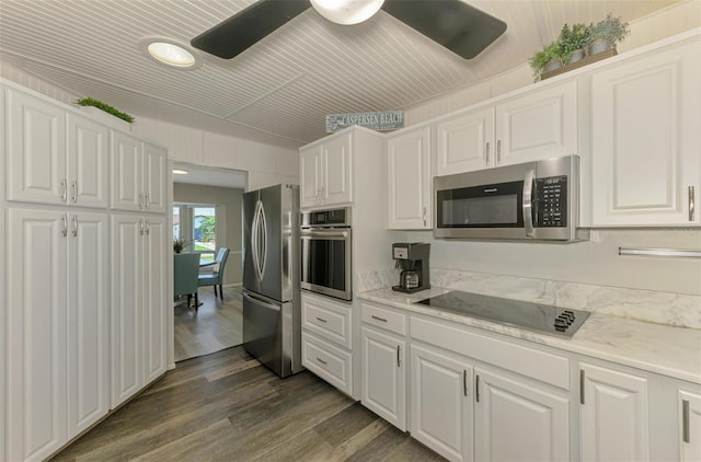 9869 Gulfstream Blvd, Englewood, FL 34224 - kitchen with stainless steel appliances, white cabinetry, light countertops, dark wood-style flooring, and recessed lighting
