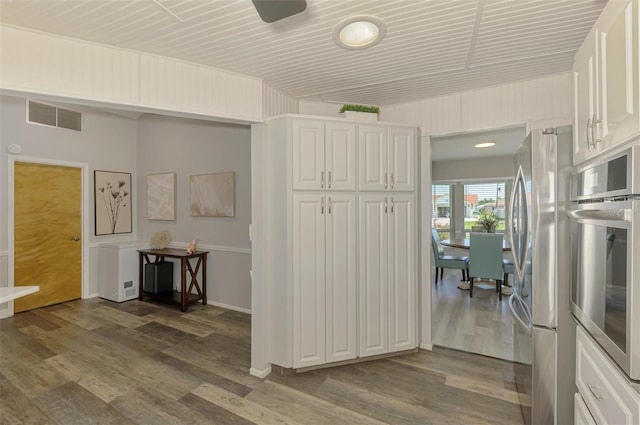9869 Gulfstream Blvd, Englewood, FL 34224 - kitchen featuring appliances with stainless steel finishes, white cabinetry, and dark wood finished floors