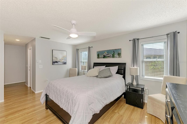 9869 Gulfstream Blvd, Englewood, FL 34224 - bedroom with light wood-type flooring, a textured ceiling, baseboards, and ceiling fan