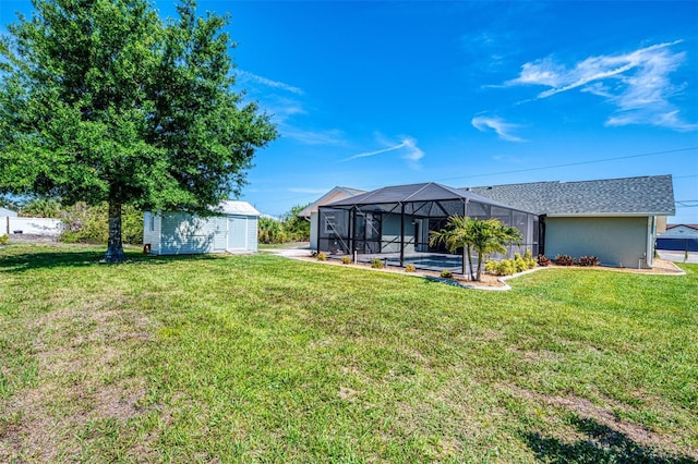9869 Gulfstream Blvd, Englewood, FL 34224 - view of grassy yard featuring an outdoor structure, a shed, and a lanai