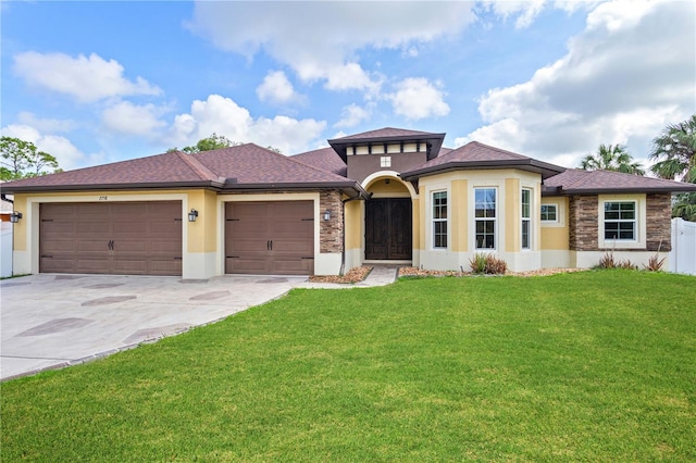 2758 Morrietta Ln, North Port, FL 34286 - view of front of home featuring stucco siding, a garage, concrete driveway, stone siding, and a shingled roof
