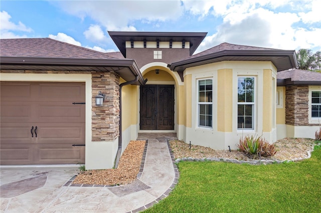 2758 Morrietta Ln, North Port, FL 34286 - view of front facade featuring stone siding, an attached garage, stucco siding, and a front yard