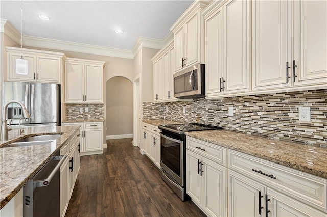 2758 Morrietta Ln, North Port, FL 34286 - kitchen with stainless steel appliances, a sink, ornamental molding, decorative backsplash, and light stone countertops