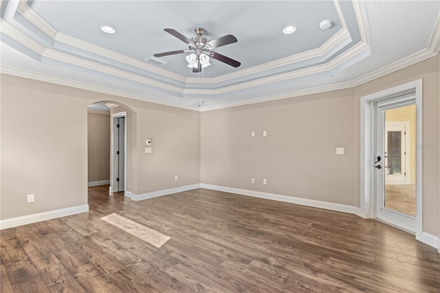 2758 Morrietta Ln, North Port, FL 34286 - unfurnished room featuring a tray ceiling, ceiling fan, ornamental molding, arched walkways, and wood finished floors
