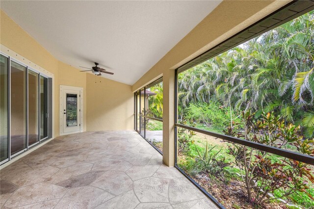 2758 Morrietta Ln, North Port, FL 34286 - unfurnished sunroom featuring vaulted ceiling and stone finish floors