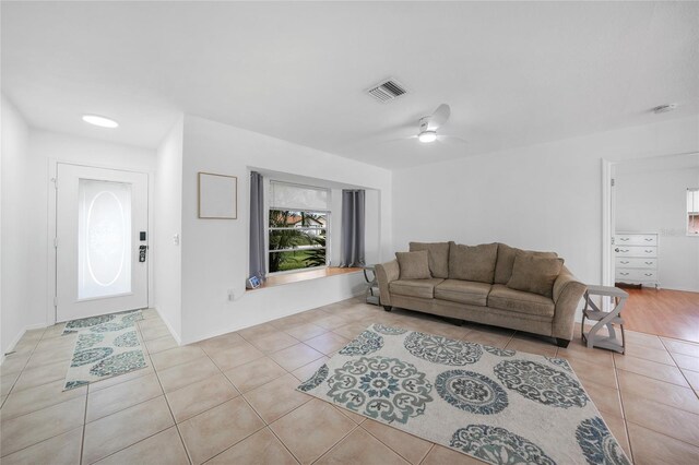279 Mark Twain Ln, Rotonda West, FL 33947 - living area featuring light tile patterned floors and a ceiling fan
