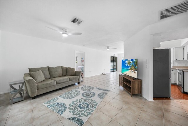 279 Mark Twain Ln, Rotonda West, FL 33947 - living room with ceiling fan and light tile patterned flooring