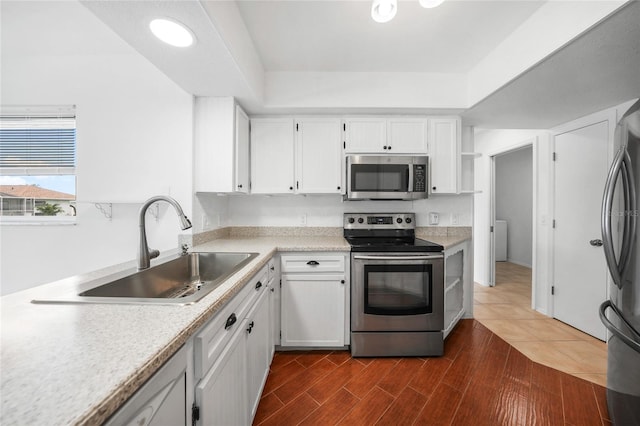 279 Mark Twain Ln, Rotonda West, FL 33947 - kitchen featuring appliances with stainless steel finishes, a sink, white cabinets, light countertops, and dark wood-style floors