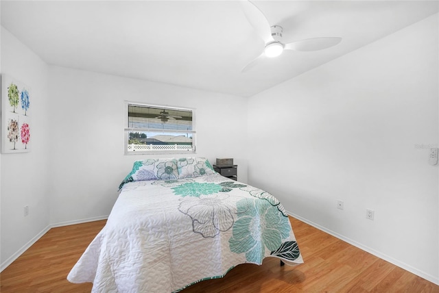 279 Mark Twain Ln, Rotonda West, FL 33947 - bedroom with wood finished floors, baseboards, and a ceiling fan