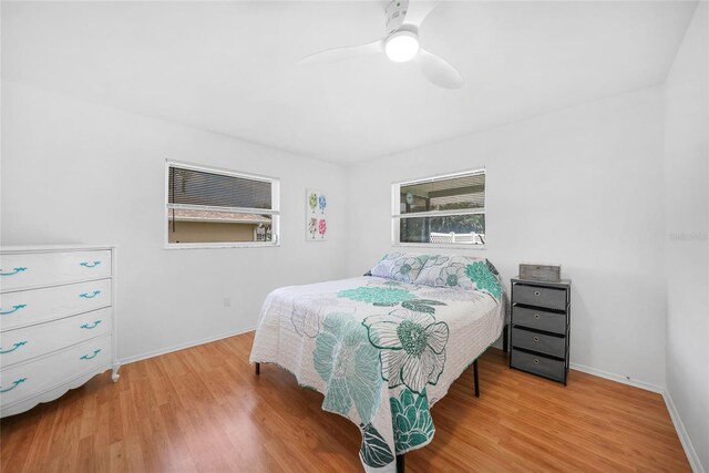 279 Mark Twain Ln, Rotonda West, FL 33947 - bedroom featuring wood finished floors, baseboards, and a ceiling fan