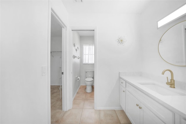 279 Mark Twain Ln, Rotonda West, FL 33947 - bathroom with tile patterned floors, toilet, vanity, and baseboards