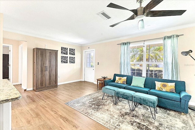 305 E Wentworth Cir, Englewood, FL 34223 - living area with ornamental molding, light wood-style floors, a ceiling fan, and baseboards