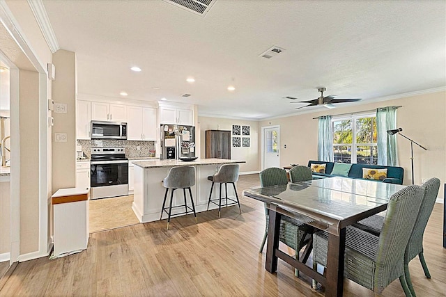 305 E Wentworth Cir, Englewood, FL 34223 - dining room featuring ornamental molding, light wood-type flooring, baseboards, recessed lighting, and ceiling fan