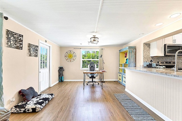 305 E Wentworth Cir, Englewood, FL 34223 - dining room with a desk, light wood-type flooring, crown molding, and baseboards