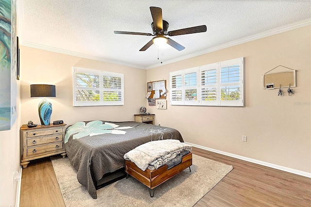 305 E Wentworth Cir, Englewood, FL 34223 - bedroom with multiple windows, wood finished floors, crown molding, baseboards, and ceiling fan