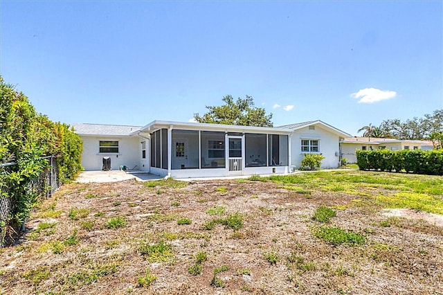 305 E Wentworth Cir, Englewood, FL 34223 - rear view of property featuring a sunroom, a fenced backyard, and a patio
