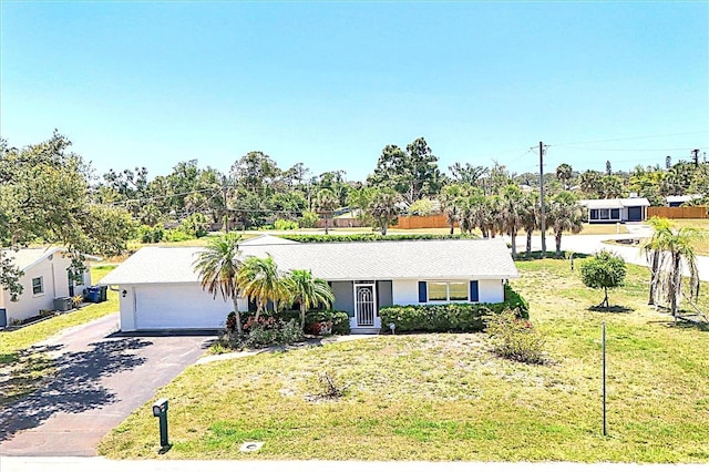 305 E Wentworth Cir, Englewood, FL 34223 - ranch-style home with asphalt driveway, a front yard, and an attached garage