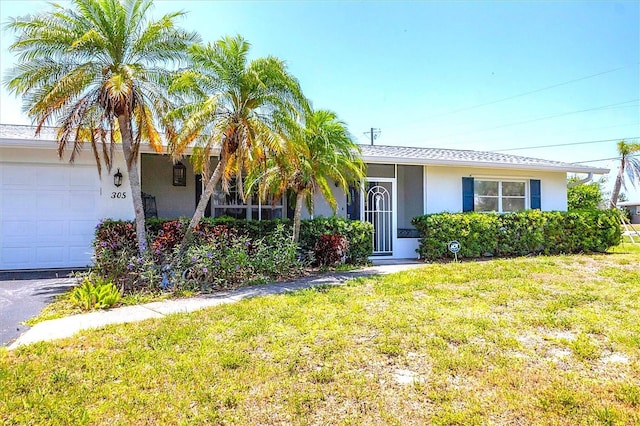 305 E Wentworth Cir, Englewood, FL 34223 - ranch-style home featuring stucco siding, a front yard, and an attached garage