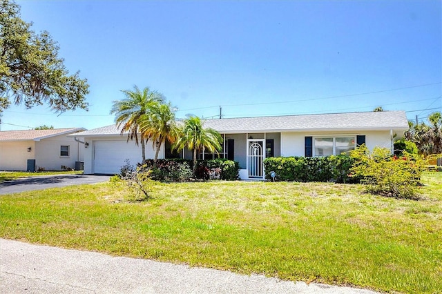 305 E Wentworth Cir, Englewood, FL 34223 - ranch-style house with a garage, stucco siding, a front yard, and driveway