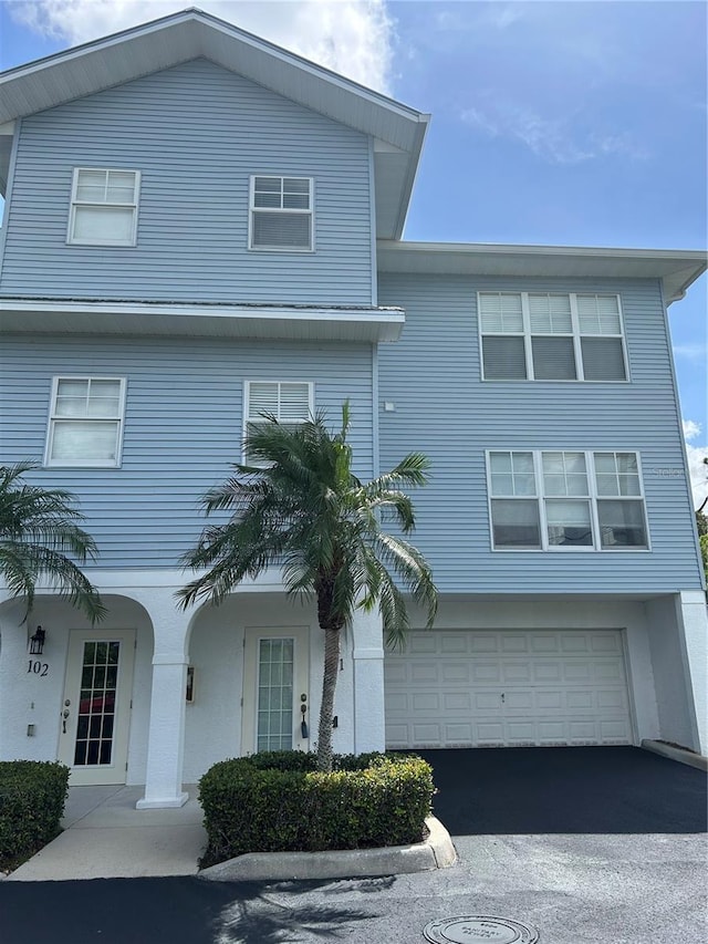 3929 Cape Haze Dr Unit 101, Rotonda West, FL 33947 - view of front facade with a garage and driveway