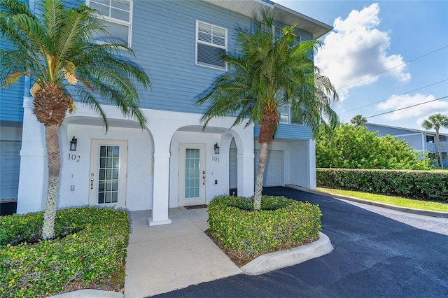 3929 Cape Haze Dr Unit 101, Rotonda West, FL 33947 - view of front of home featuring an attached garage, driveway, and stucco siding